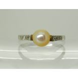 A white metal diamond and pearl set ring, size N, weight 2.5gms Condition Report: Available upon