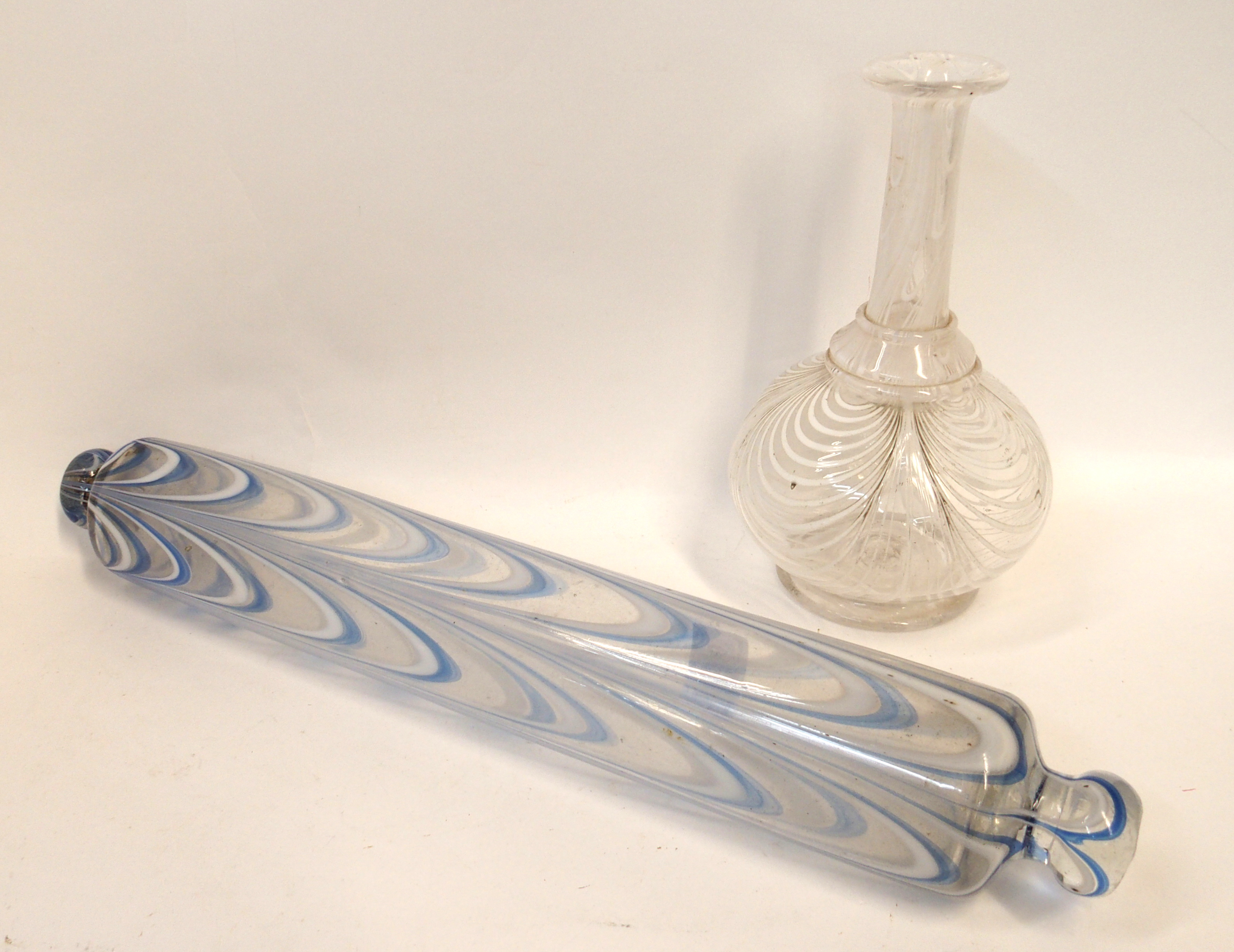 A Nailsea style glass rolling pin together with a similar vase Condition Report: Available upon