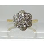 AN 18CT AND PLATINUM DIAMOND FLOWER RING of estimated approx 0.56cts in total. Finger size L1/2,