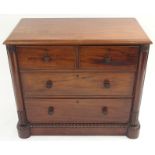A VICTORIAN MAHOGANY TWO OVER TWO CHEST OF DRAWERS turned handles with column supports on a carved