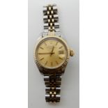A LADIES ROLEX OYSTER PERPETUAL DATE IN GOLD AND STAINLESS STEEL with gold coloured dial baton