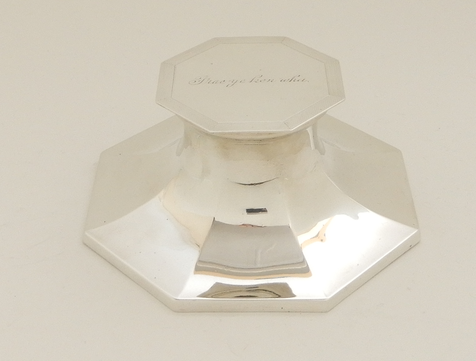 A SILVER INKWELL by Deakin & Francis Limited, Birmingham 1937, of octagonal Capstan form, the hinged