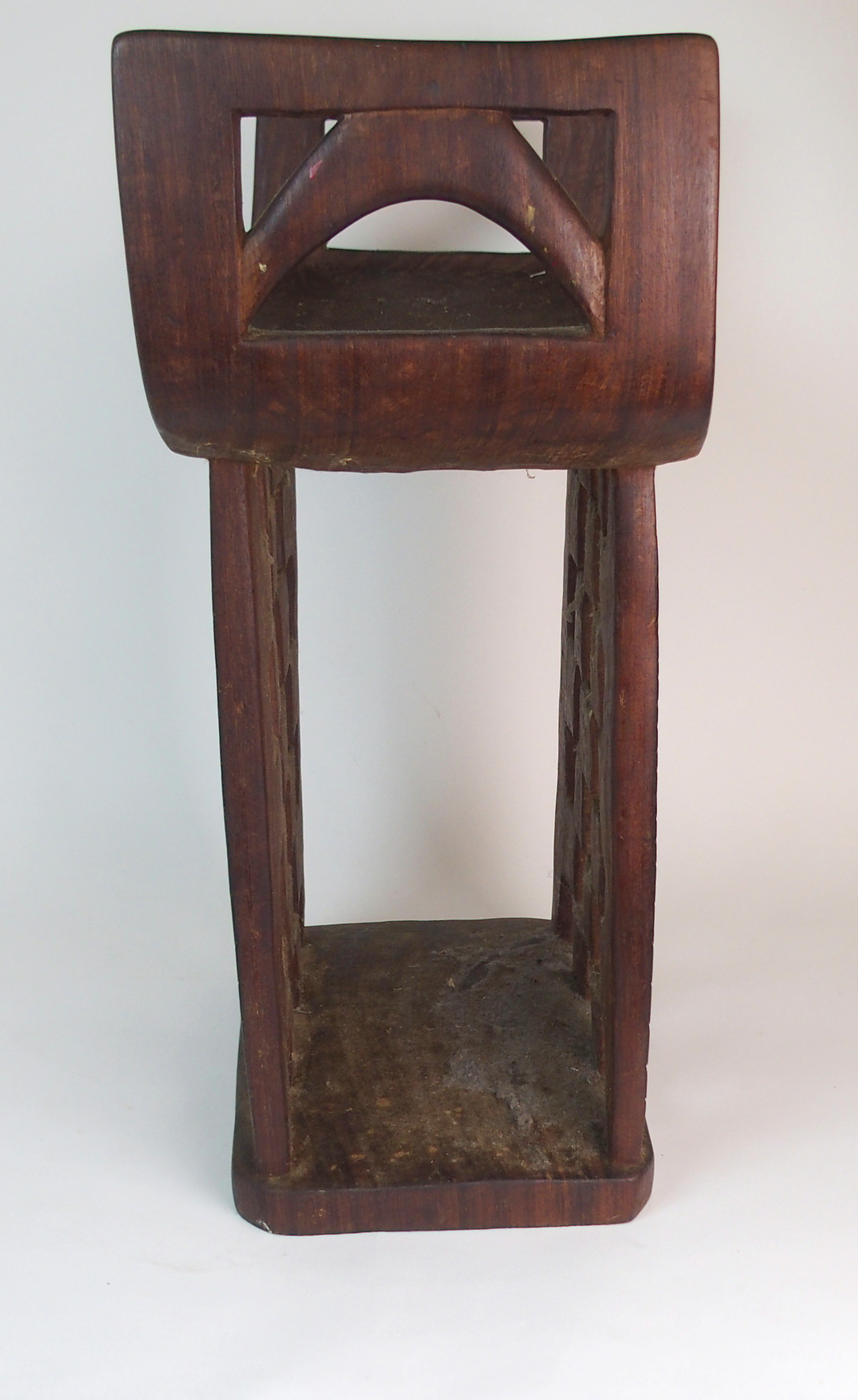 *WITHDRAWN* AN AFRICAN TRIBAL HARDWOOD CIRCULAR TABLE with deep carved rim above a pair of curved - Image 7 of 8