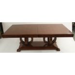 A SELVA TOSCA EXTENDING DINING TABLE with two extra leaves, the base having two intersecting circles