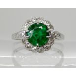 AN 18CT WHITE GOLD EMERALD AND DIAMOND RING the emerald is approx 7.1mm x 6.7mm x 4.9mm,