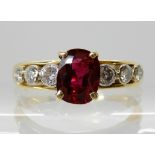 A BRIGHT YELLOW METAL RUBY AND DIAMOND RING ruby approx 7.1mm x 5.5mm x 2.9mm, diamond content