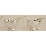 A CASED PAIR OF SILVER SAUCEBOATS by Henry Clifford Davis, Birmingham 1963, of classic plain shape