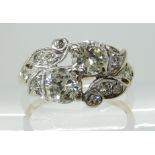 A TWIN STONE DIAMOND RING WITH DIAMOND SET STYLISED BIRD DETAIL set in yellow and white 14k gold,