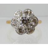 AN 18CT YELLOW AND WHITE GOLD DIAMOND FLOWER RING set with estimated approx 0.40cts to the centre