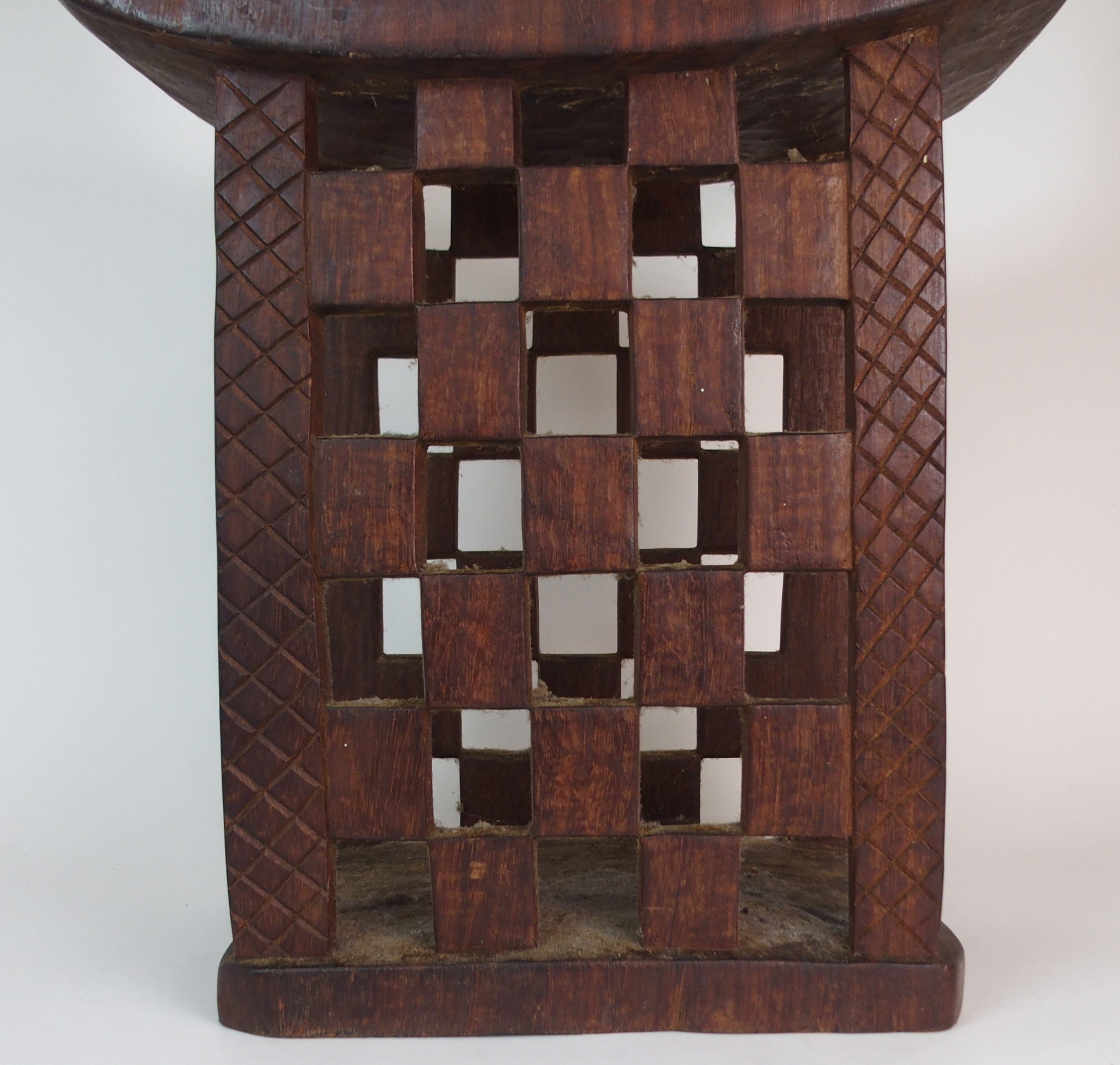 *WITHDRAWN* AN AFRICAN TRIBAL HARDWOOD CIRCULAR TABLE with deep carved rim above a pair of curved - Image 5 of 8