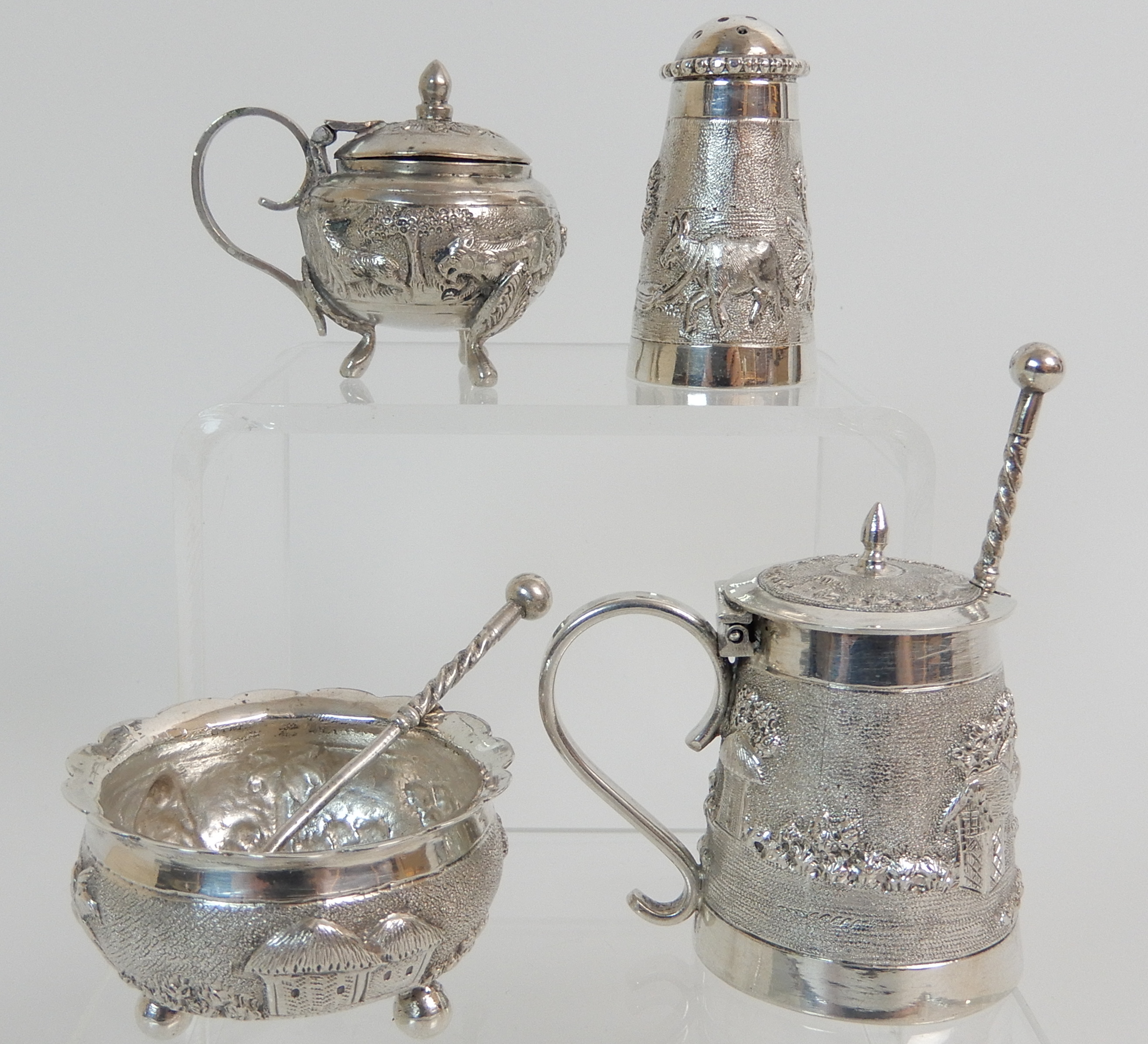 FOUR BURMESE EXPORT SILVER CONDIMENTS comprising two mustard pots, a salt and a pepperette with