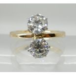 A BRIGHT YELLOW AND WHITE METAL TWIN STONE DIAMOND RING both diamonds are estimated at approx 0.