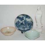 A CHINESE BLUE AND WHITE DISH painted with figures in a garden, 21.5cm diameter, two incised
