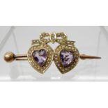 A YELLOW METAL TWIN AMETHYST HEART AND SEED PEARL BROOCH length 4.5cm, weight 4.4gms Condition