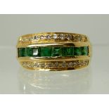 AN EMERALD AND DIAMOND DRESS RING the emeralds are approx 3mm x 3mm and set with two rows of
