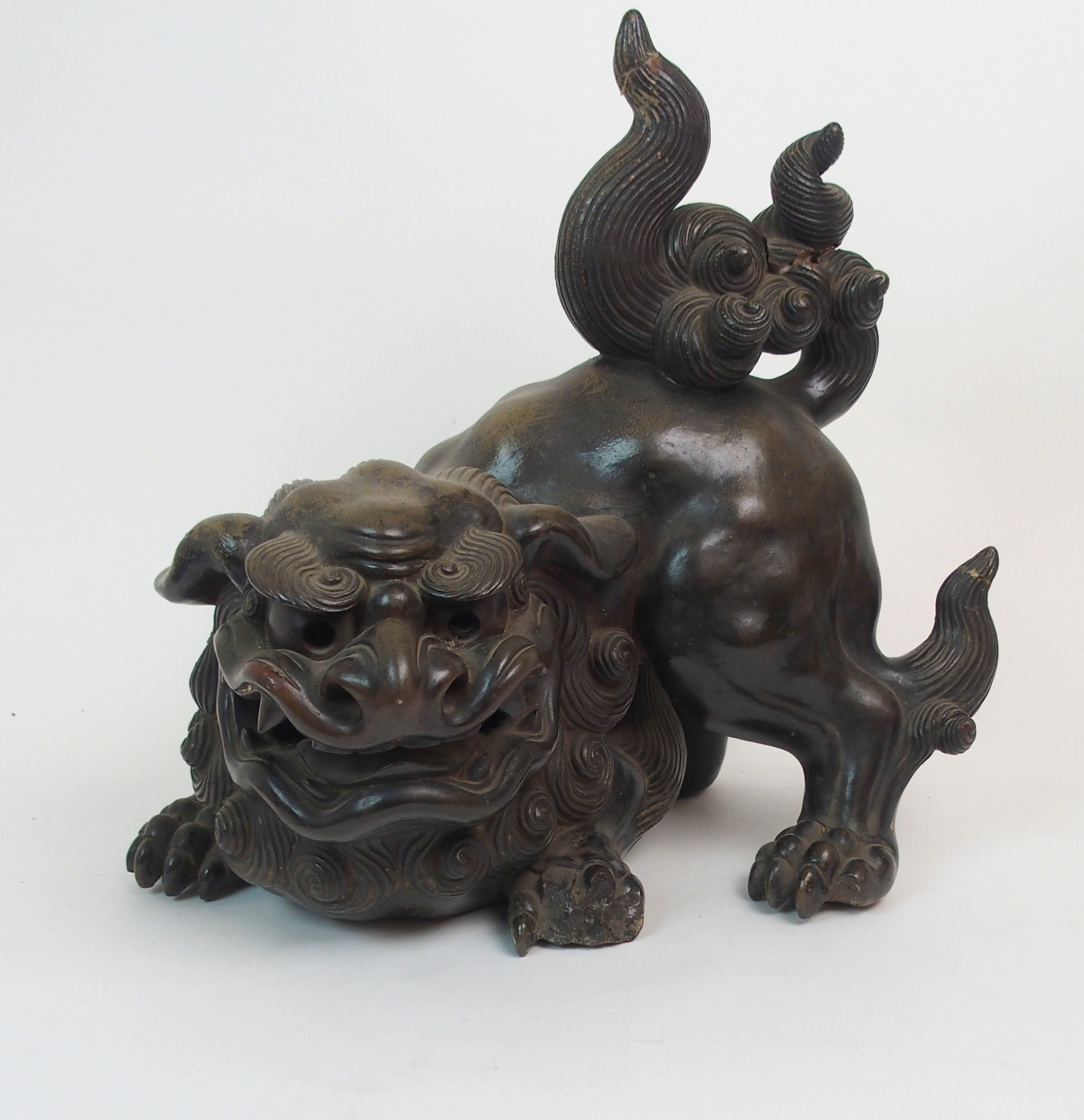 A LARGE CHINESE PAINTED TERRACOTTA BUDDHISTIC LION modelled in aggressive stance with mouth roaring,