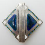 A LIBERTY & CO SILVER AND ENAMEL BUCKLE of lozenge shape, planished texture with blue green and