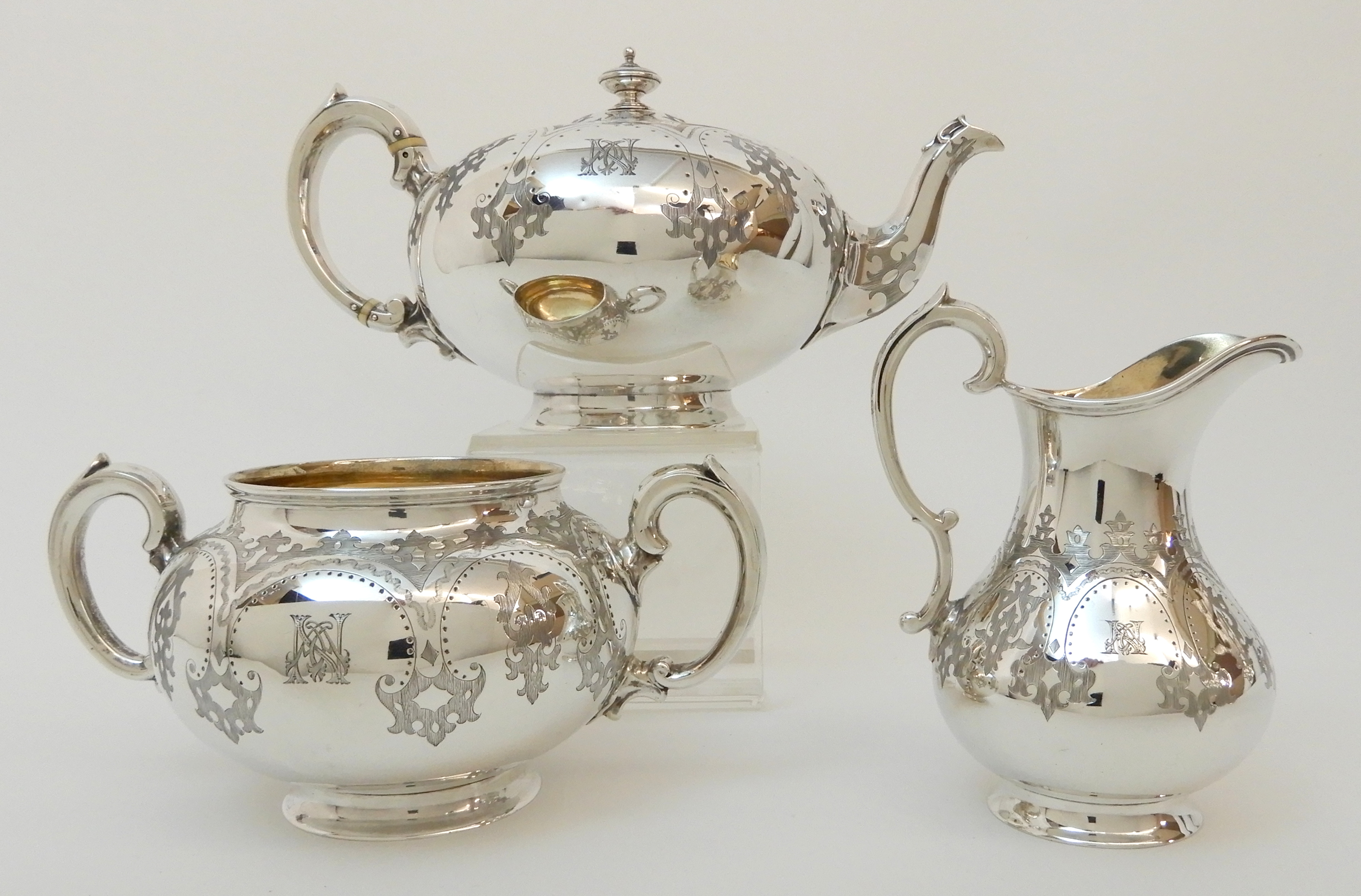 A MATCHED VICTORIAN SILVER THREE PIECE TEA SERVICE by Robert Harper, London 1867, the cream jug