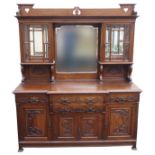A STAINED OAK ARTS AND CRAFTS MIRROR BACKED SIDEBOARD the upper section comprising central mirror