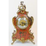 A ROCOCO STYLE FRENCH BOULLE CLOCK the gilded brass dial having raised decoration and black Roman