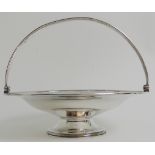 A VICTORIAN SILVER SWING HANDLED BASKET by Robert Harper, London 1869, of circular form with