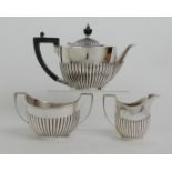 A THREE PIECE SILVER TEA SERVICE by Roberts & Belk, Sheffield 1912, of oval form with half ribbed