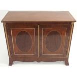 *A VICTORIAN MAHOGANY INLAID TWO DOOR COLLECTORS CABINET with gilt supports and roundels with four