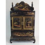 A JAPANESE BLACK AND GOLD LACQUERED CABINET decorated with views of Mount Fuji, fitted with a pair
