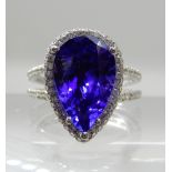 AN 18CT WHITE GOLD TANZANITE AND DIAMOND DRESS RING with insurance documents that state the pear