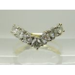 AN 18CT YELLOW AND WHITE GOLD SEVEN STONE DIAMOND 'V' SHAPED RING set with estimated approx 0.