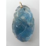 AN ORIENTAL CARVED FLUORITE PENDANT carved with a small mammal with a bushy tail among fruiting