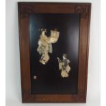 THREE JAPANESE ONLAID WALL PLAQUES each decorated with a mother and child holding a scroll and