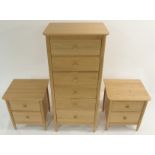 A LIGHT ERCOL TERAMO NARROW SIX DRAWER CHEST with tapered legs, 140cm high x 63cm wide x 47cm deep