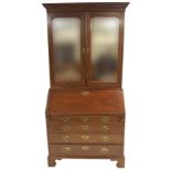 A 19TH CENTURY MAHOGANY BUREAU CABINET with fitted interior of drawers and pigeon holes with a