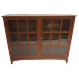 AN L & J STICKLEY OAK ARTS AND CRAFTS BOOKCASE two doors with nine glazed panels on square legs with