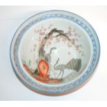 A CANTONESE BOWL the well painted with a peacock and hen amongst blossoming trees and rockery,