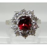 AN 18CT WHITE GOLD AND PLATINUM RUBY AND DIAMOND CLUSTER RING the central ruby measures approx 6.2mm