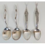 A PAIR OF EASTERN SERVING SPOONS marked Thailand sterling, the shaped stem with a seated Buddha amid