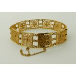 A BRIGHT YELLOW METAL FILIGREE BRACELET with Chinese makers marks, length 18.5cm, width 1.4cm,