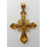 A BRIGHT YELLOW METAL CITRINE SET CROSS with pierced filigree detail to the centre, the citrines are
