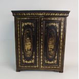 A CHINESE BLACK AND GOLD LACQUERED CABINET the moulded cornice above a pair of painted doors