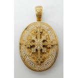 A BRIGHT YELLOW METAL AND ENAMEL LOCKET BACK PENDANT with applied enamelled cross motif,