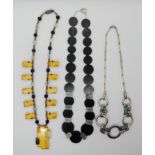 THREE ART DECO STYLE NECKLACES A yellow and black carved lucite, chrome metal and glass bead