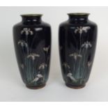 A PAIR OF JAPANESE CLOISONNE BALUSTER VASES decorated with cranes beneath tall irises and aquatic