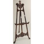 A CHINESE HARDWOOD ARTISTS EASEL with carved dog finials with pierced back at top and base, 194cm