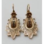 A PAIR OF VICTORIAN YELLOW METAL AND BLACK ENAMEL EARRINGS with flower finials and palmette design