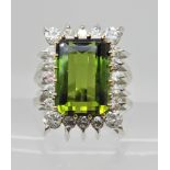 AN 18CT WHITE GOLD RETRO TOURMALINE AND DIAMOND RING the emerald cut green tourmaline measures 12.