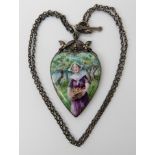 AN ARTS & CRAFTS PENDANT with a finely painted enamel plaque of a maiden picking apples, in white