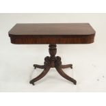 A VICTORIAN MAHOGANY FOLD-OVER TEA TABLE on a turned pedestal base with barley twist on quatrefoil
