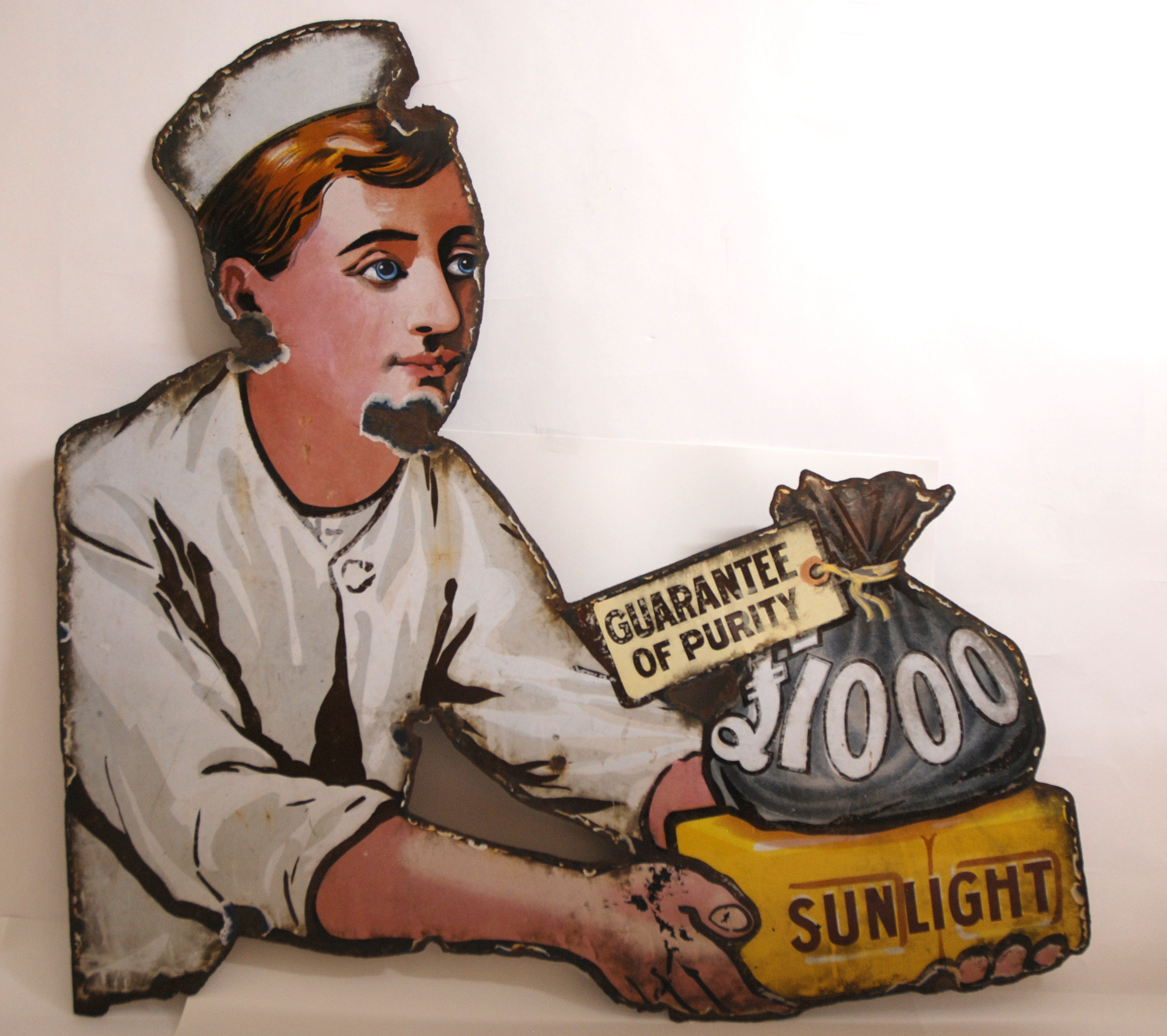 A SHAPED SUNLIGHT SOAP ENAMEL ADVERTISING SIGN with areas of wear, 80cm high x 82cm wide Condition